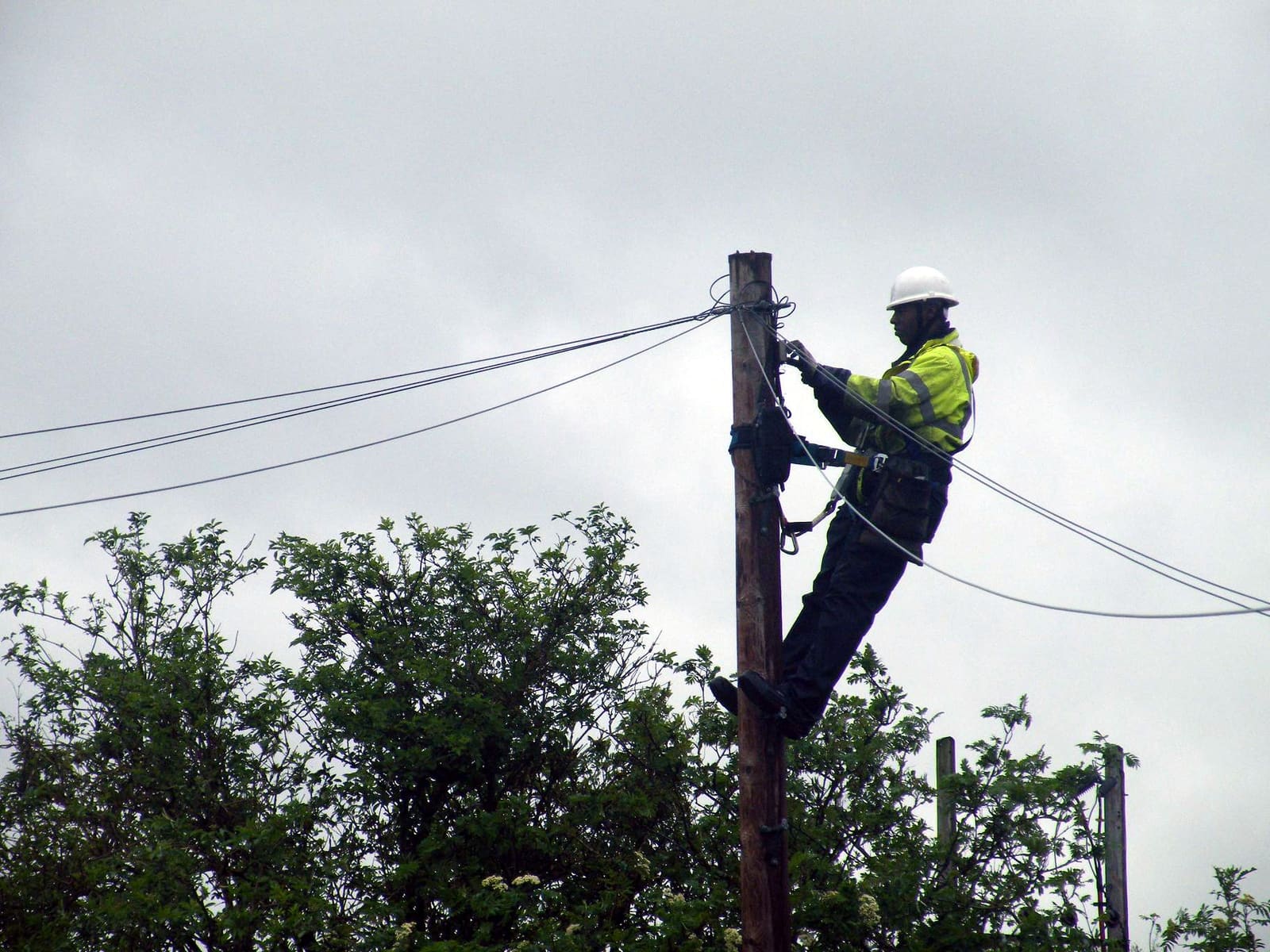 An Openreach engineer working up a telegraph pole