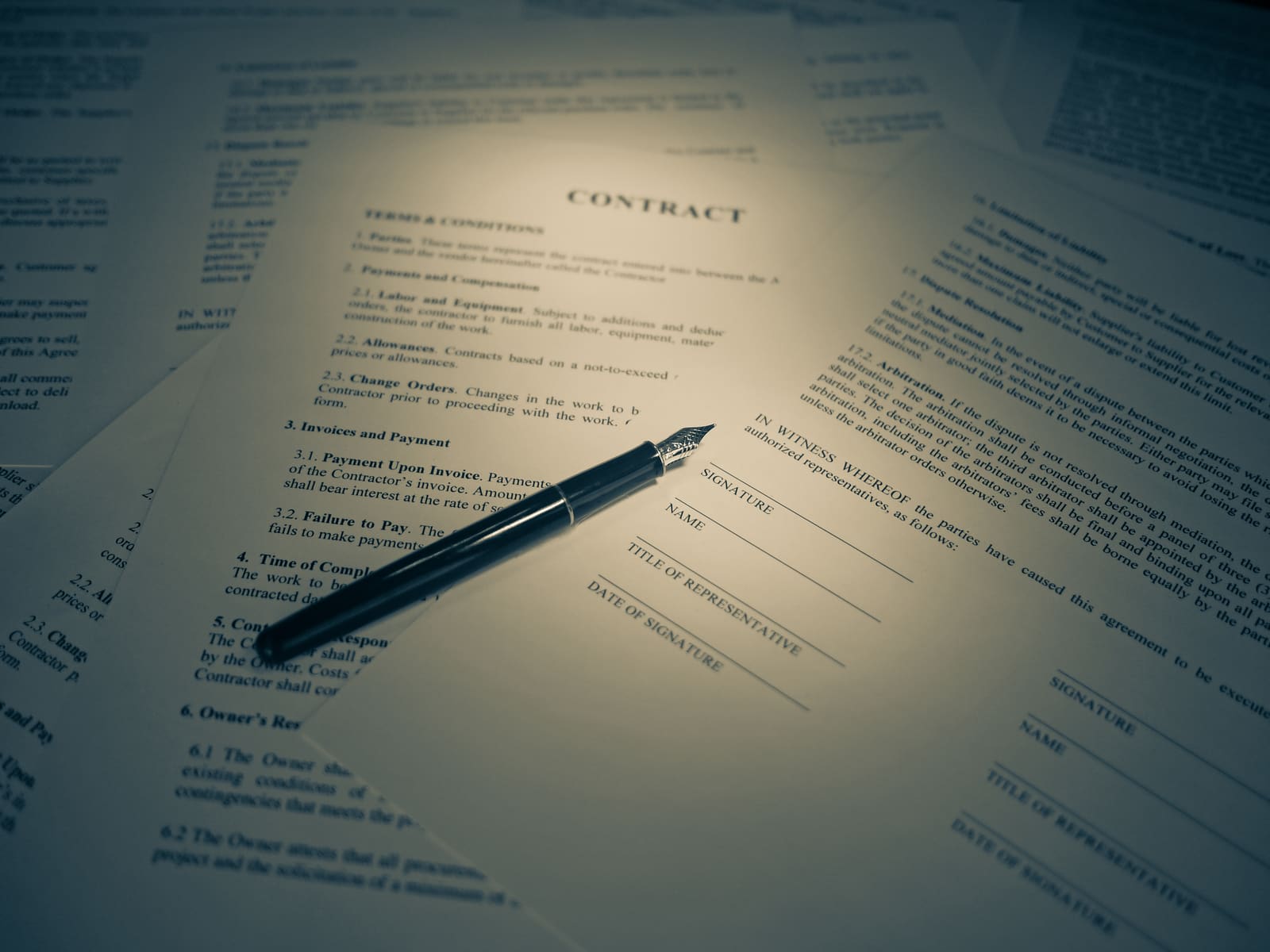Contracts laid out for signature with a fountain pen