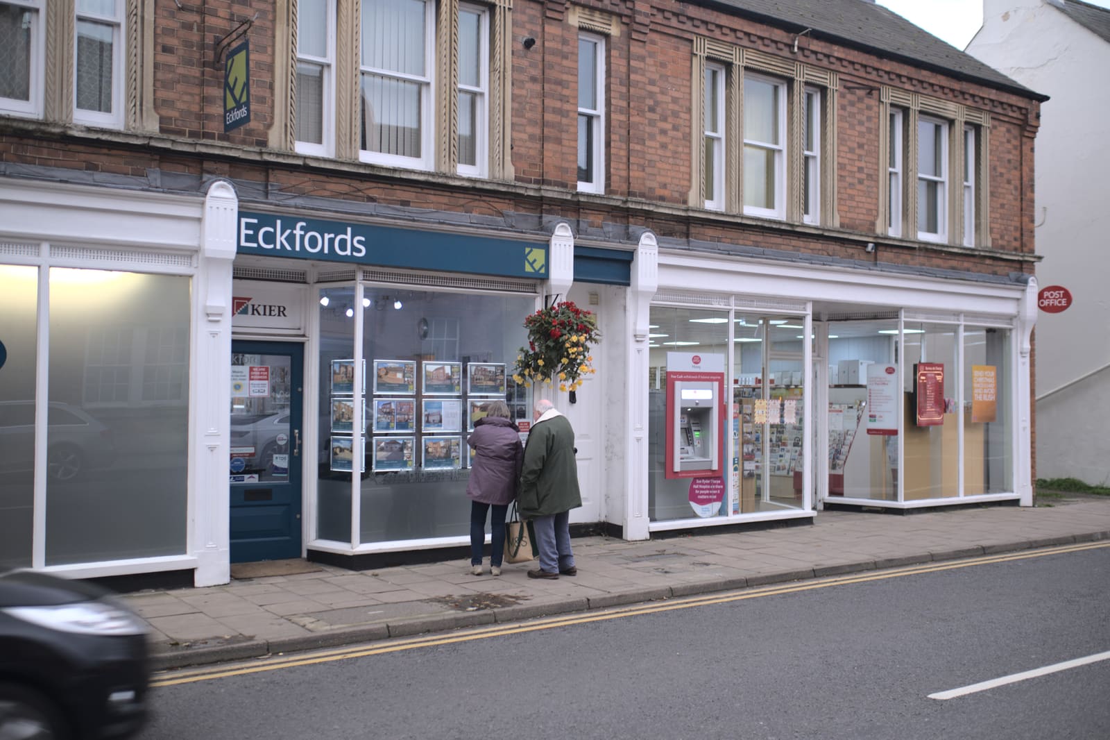 Buyers browsing an estate agent’s window display