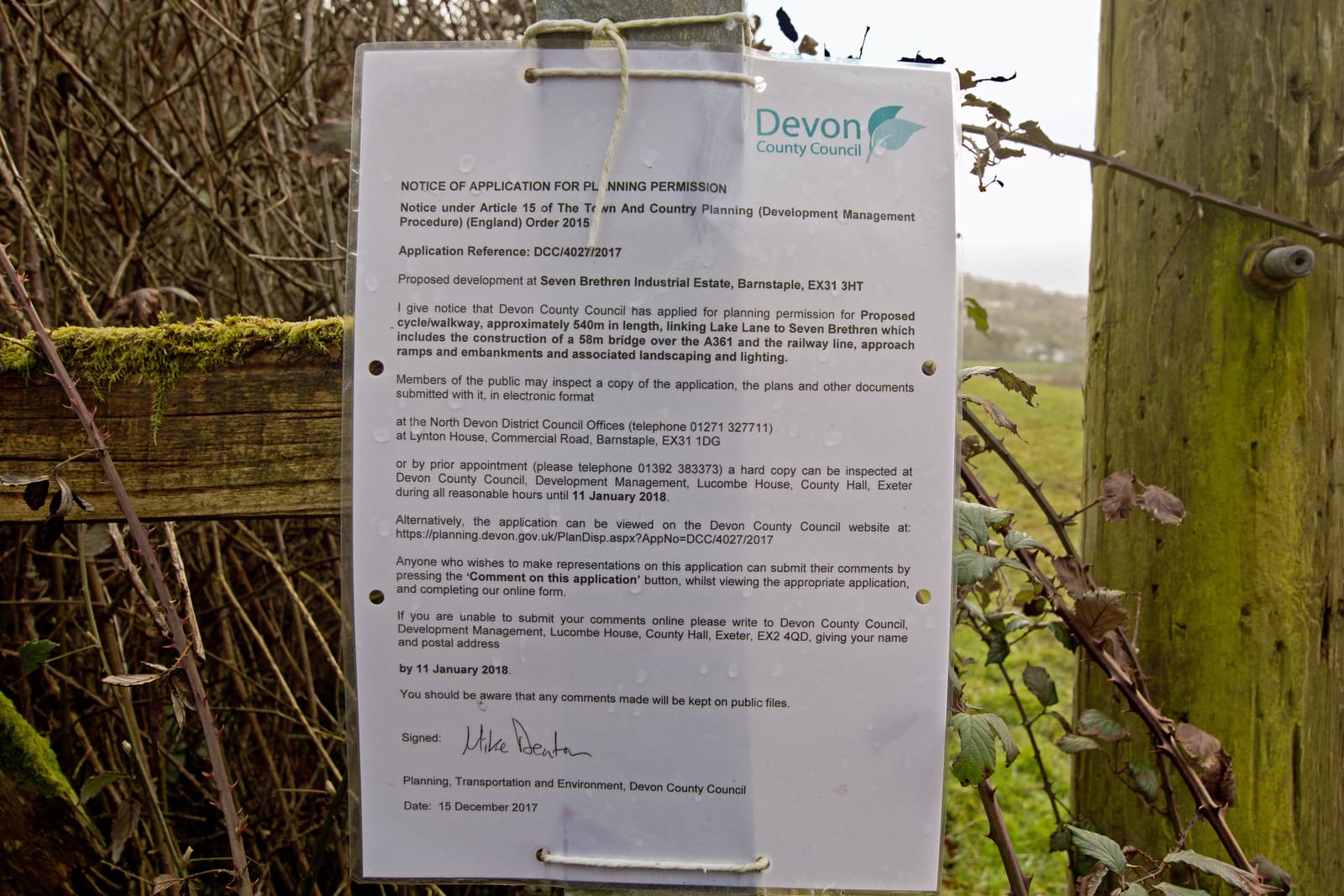 A planning application notice on a post